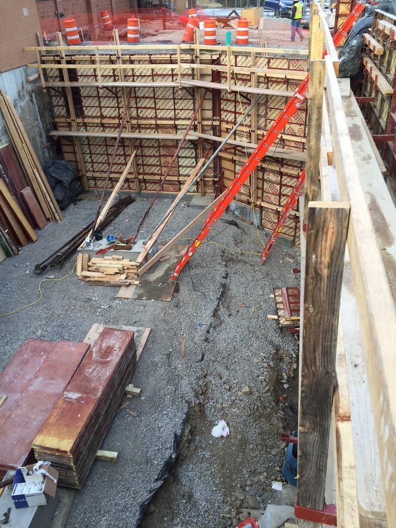 Form ties and hardware bracing a deep formwork wall