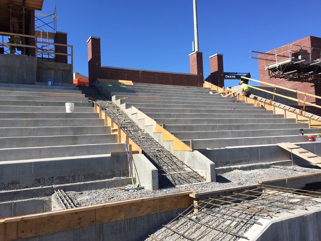 Finished poured-in-place stadium steps under a clear sky